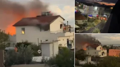 Muratpaşa'da iki katlı bir evin çatısında çıkan yangın, itfaiye ekiplerinin